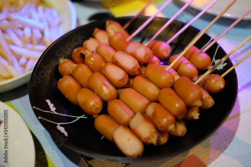 Mini sausages on wooden skewers. 