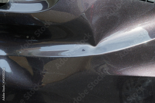 a black car body dent needs a repair