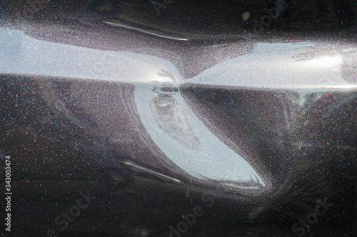 a black car body dent needs a repair