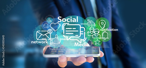 Businessman holding a cloud of social media network icon photo