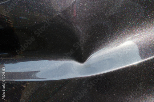 a black car body dent needs a repair