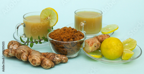 Ginger juice with lemon and brown sugar in a cup and saucer