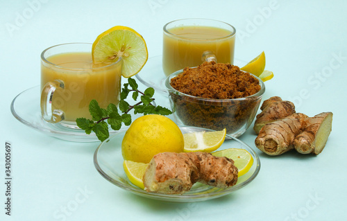 Ginger juice with lemon and brown sugar in a cup and saucer