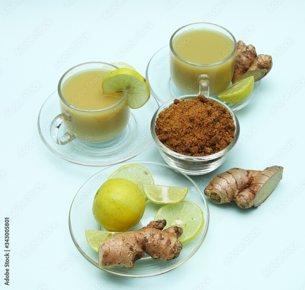 Ginger juice with lemon and brown sugar in a cup and saucer Ginger juice with lemon and brown sugar in a cup and saucer