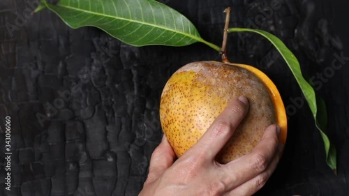 Apple mangoes on a black wooden background