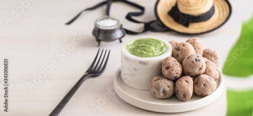 Local Canary Islands dish, Papas Arrugadas (wrinkly potatoes) with Mojo Verde (green sauce). photo