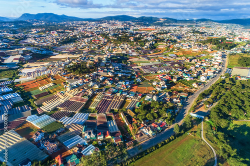 Top view aerial photo from flying drone of a Da Lat City with development buildings  transportation. Tourist city in developed Vietnam. Mai Anh Dao street  ward 8  near Love Valley park. 
