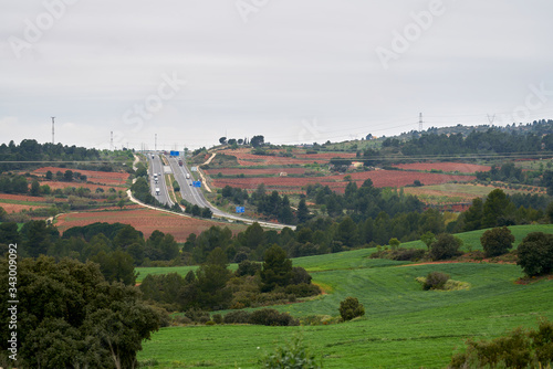 highway with several lanes where several trucks circulate photo