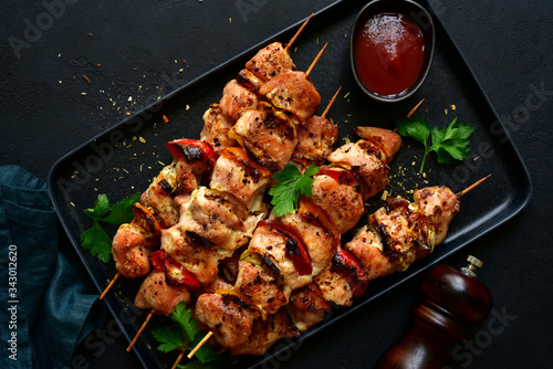 Grilled chicken kebab with vegetables and greens. Top view with copy space.