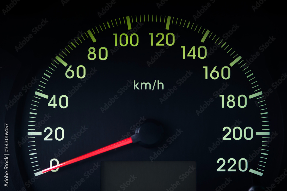 Close-Up of a Glowing black car Speedometer with a red arrow indicating 0 Close-Up of a Glowing black car Speedometer with a red arrow indicating 0