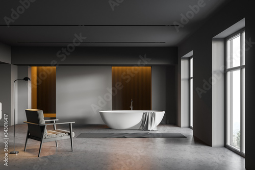 Dark gray bathroom, tub and armchair