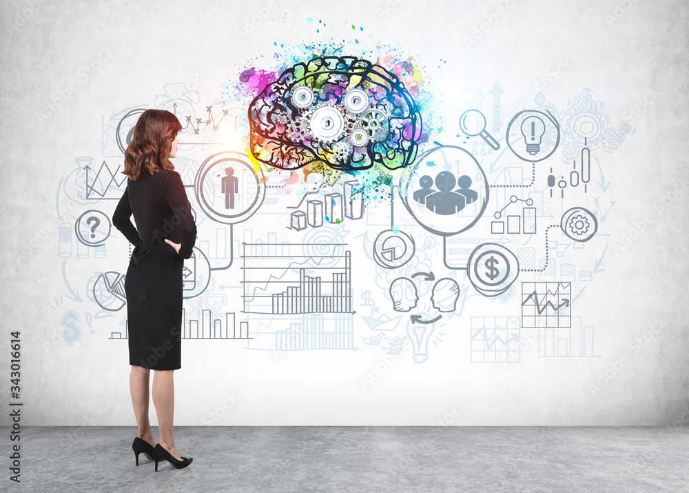 Woman looking at business sketch, brainstorming Woman looking at business sketch, brainstorming