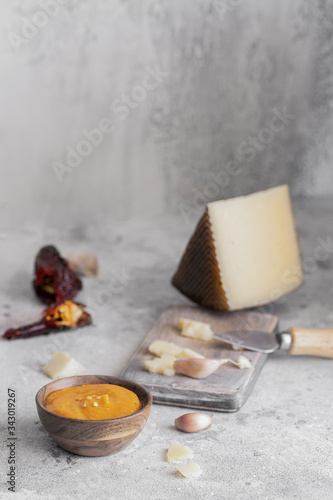 Almogrote, cheese paste form La Gomera, Canary Islands in wooden bowl on concrete table.Coipy space