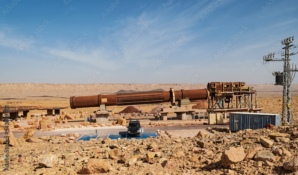 antique historic mining apparatus in an abandoned quarry in the makhtesh ramon crater in israel with gaash hill and the north rim in the background antique historic mining apparatus in an abandoned quarry in the makhtesh ramon crater in israel with gaash hill and the north rim in the background