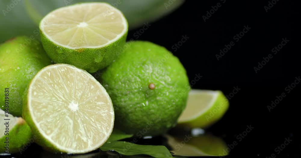 In half of fresh lime falling water drops. In half of fresh lime falling water drops.