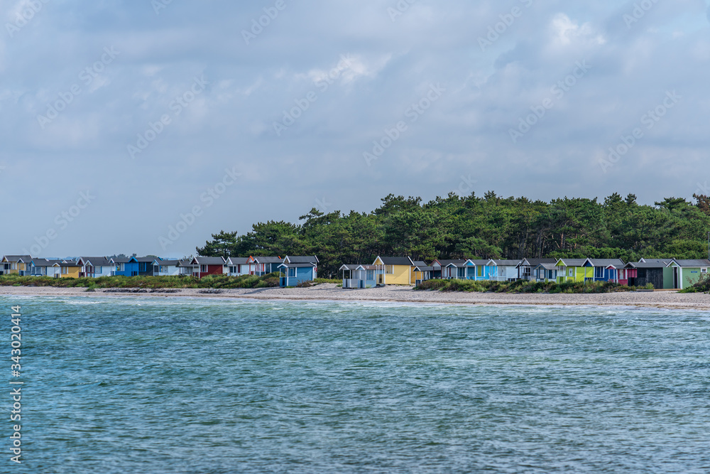 Row of colorful cabins at the beach of Skanor in Sweden