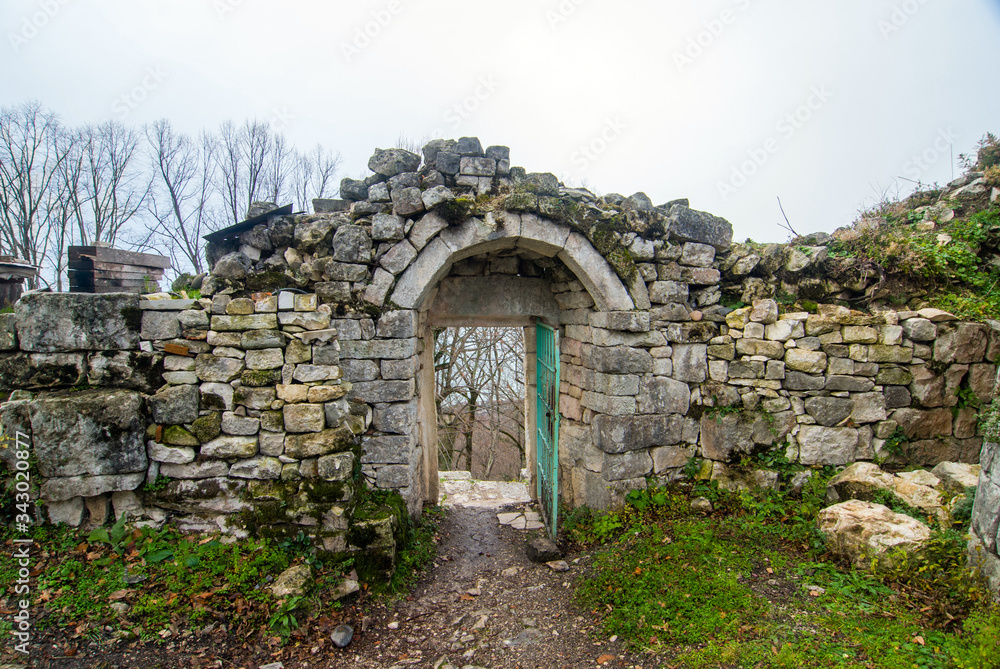 Winter view of the arch of the ruins of the fortress of Anakopia of the 7th century on the Iverskaya mountain in New Athos.