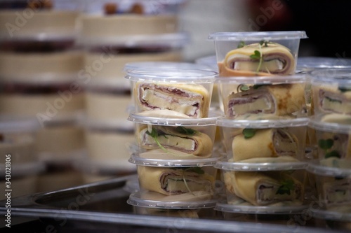 scenes from commercial kitchen preparing food for take away and delivery