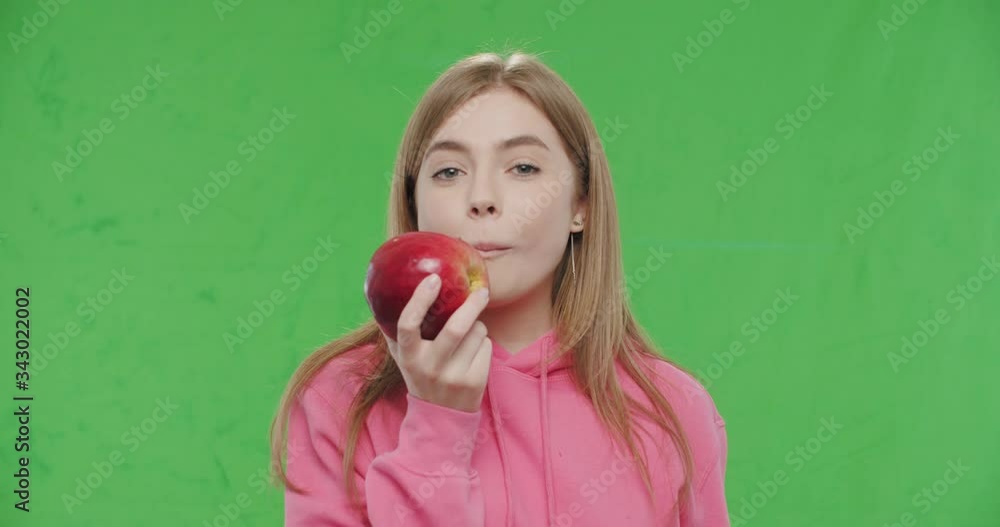 woman biting big fresh red apple woman biting big fresh red apple