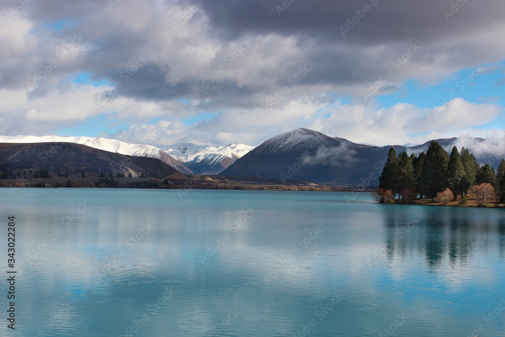 Snow capped mountains on the lake. Wintery landscapes of Otago, New Zealand.  