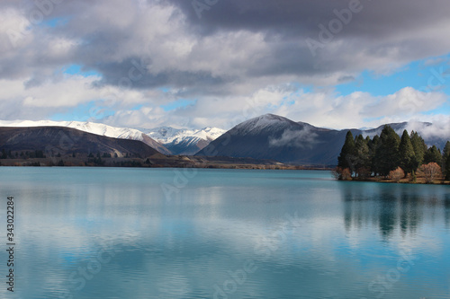 Snow capped mountains on the lake. Wintery landscapes of Otago, New Zealand. 