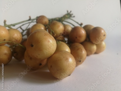 Baccaurea motleyana, a sweet, sour Thai yellow fruit on a white background. photo