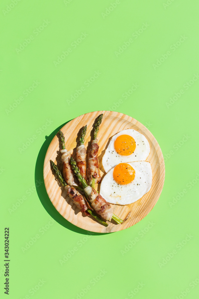 Keto, ketogenic breakfast, meal with fried eggs, bacon, asparagus Keto, ketogenic breakfast, meal with fried eggs, bacon, asparagus
