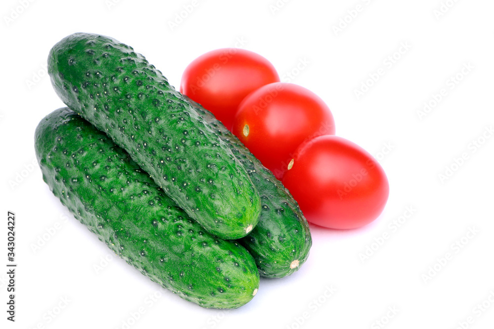 Organic, raw vegetables isolated.Tomatoes and cucumbers isolated on a white background. Organic, raw vegetables isolated.Tomatoes and cucumbers isolated on a white background.