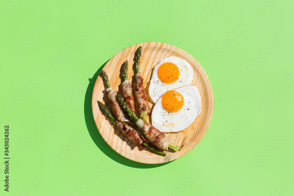 Keto, ketogenic breakfast, meal with fried eggs, bacon, asparagus Keto, ketogenic breakfast, meal with fried eggs, bacon, asparagus