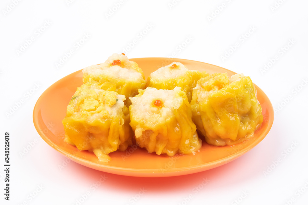 Siu Mai - Chinese steamed pork dumplings on plate isolated on white background. Siu Mai - Chinese steamed pork dumplings on plate isolated on white background.