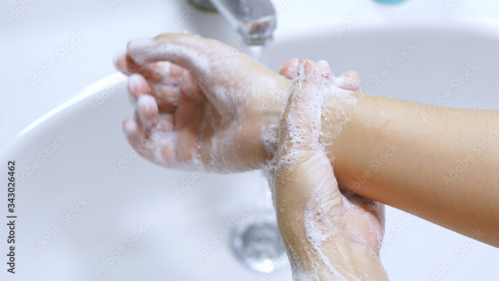Concept of health cleaning and preventing from Coronavirus or COVID-19 pandemic prevention wash hands with soap and warm water rubbing fingers washing frequently or using hand sanitizer gel