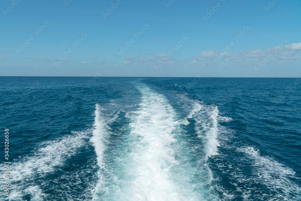 Ship Sailing on Ocean. Waves from the back of a speed boat over the water's surface in sea. View from the back of a ship Ship Sailing on Ocean. Waves from the back of a speed boat over the water's surface in sea. View from the back of a ship
