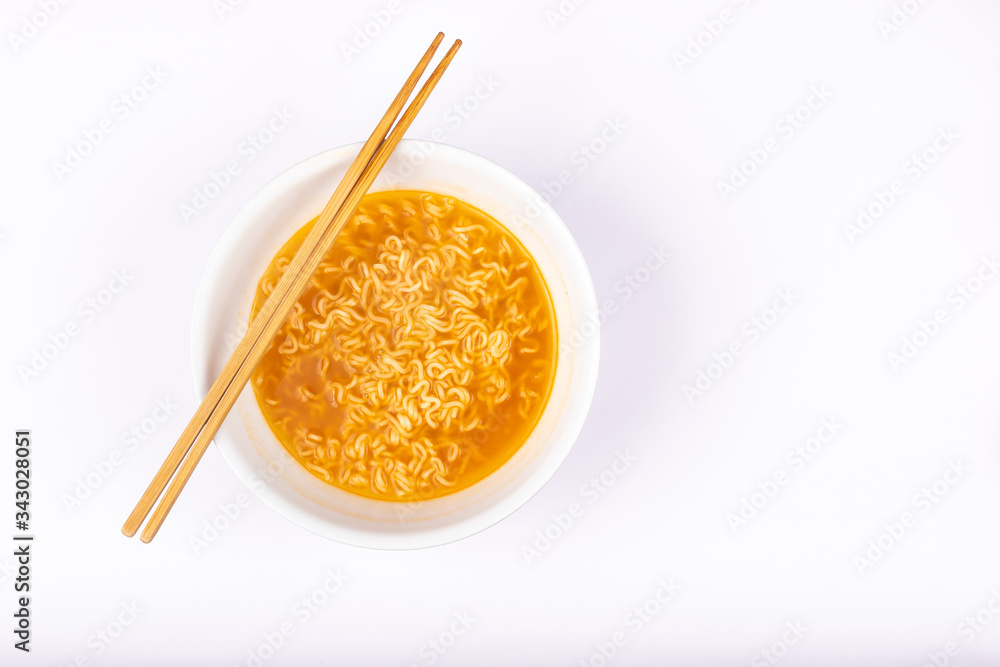 A bowl of cooked instant noodle curry taste on white background. A bowl of cooked instant noodle curry taste on white background.