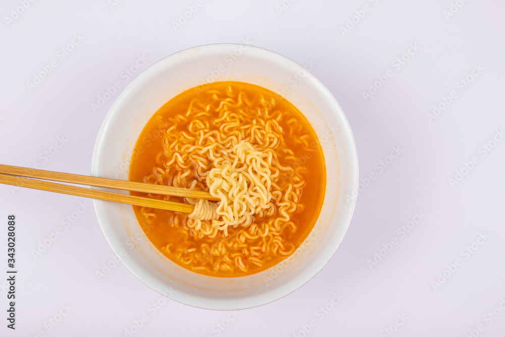 A bowl of cooked instant noodle curry taste on white background. A bowl of cooked instant noodle curry taste on white background.
