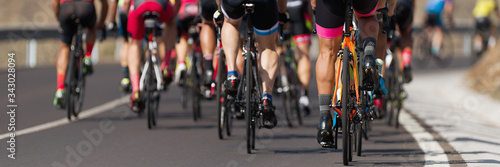 Cycling competition,cyclist athletes riding a race, the peloton climbing the mountain photo