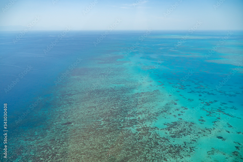 Great Barrier Reef Blue Ocean Sea view. Beautiful aqua & turquoise waters, with coral reef patterns in the ocean. View from helicopter, on vacation. Marine life, global warming, protection, island Great Barrier Reef Blue Ocean Sea view. Beautiful aqua & turquoise waters, with coral reef patterns in the ocean. View from helicopter, on vacation. Marine life, global warming, protection, island
