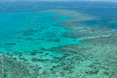 Great Barrier Reef Blue Ocean Sea view. Beautiful aqua   turquoise waters  with coral reef patterns in the ocean. View from helicopter  on vacation. Marine life  global warming  protection  island