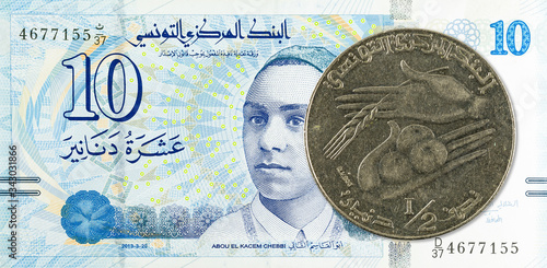 0,5 tunisian dinar coin (1990) against 10 tunisian dinar bank note new edition photo