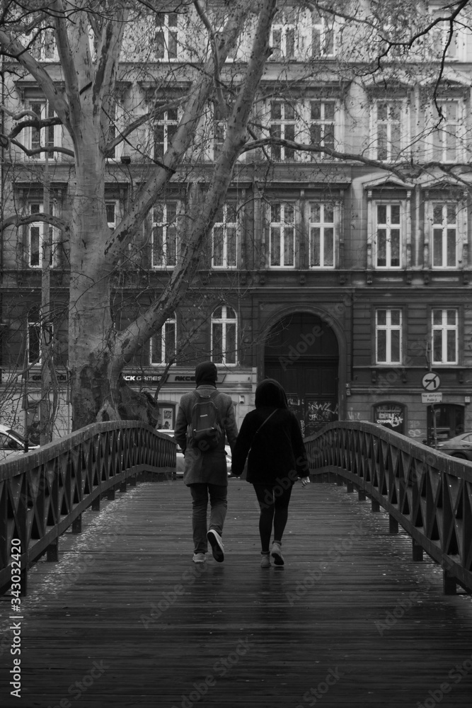 Couple walking in the city on the bridge. Black and whithe photo
