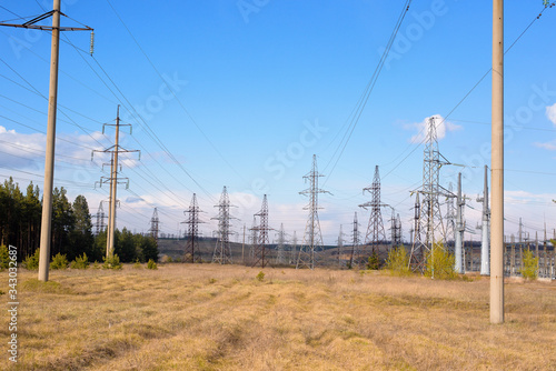 electric wires and poles with electric wires against the blue sky. panorama of nature and electricity