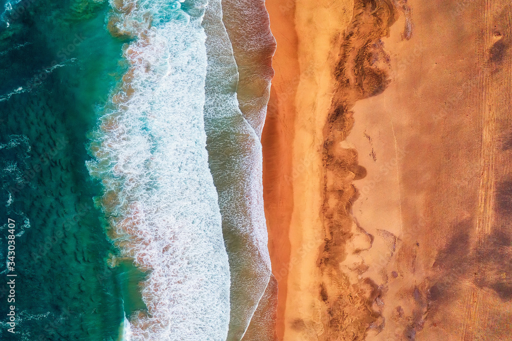 Rocky coastline and highway with golden sand and blue water Rocky coastline and highway with golden sand and blue water