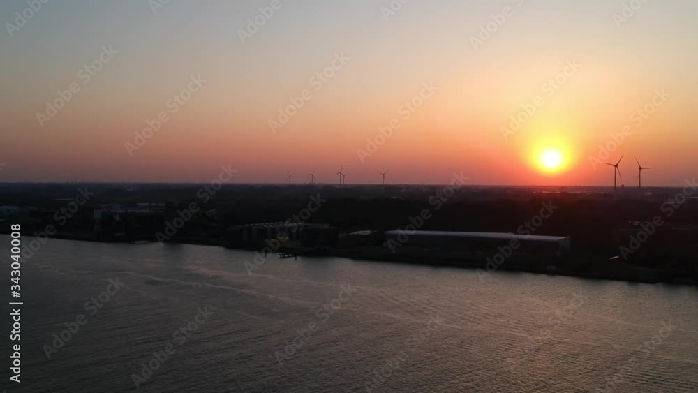 Tilt-down drone shot of boat on river at golden hour sunset. Tilt-down drone shot of boat on river at golden hour sunset.