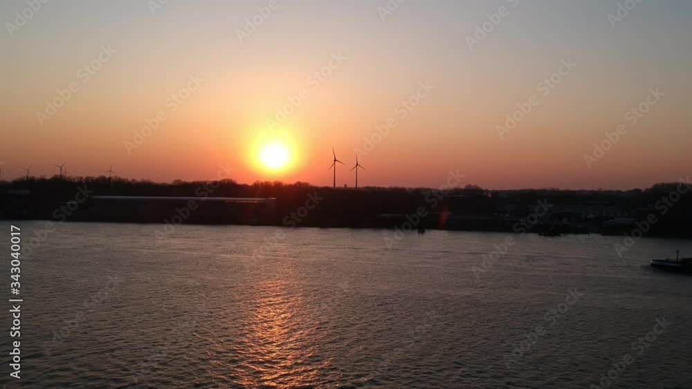 Drone shot of boat passing by on river at golden hour sunset. Drone shot of boat passing by on river at golden hour sunset.