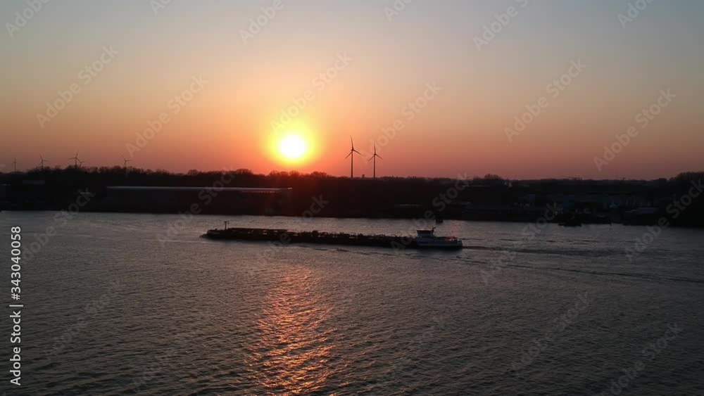 Drone shot of boat sailing by on river at golden hour sunset. Drone shot of boat sailing by on river at golden hour sunset.
