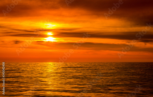 Bright colorful sunset over a calm sea © Alexander