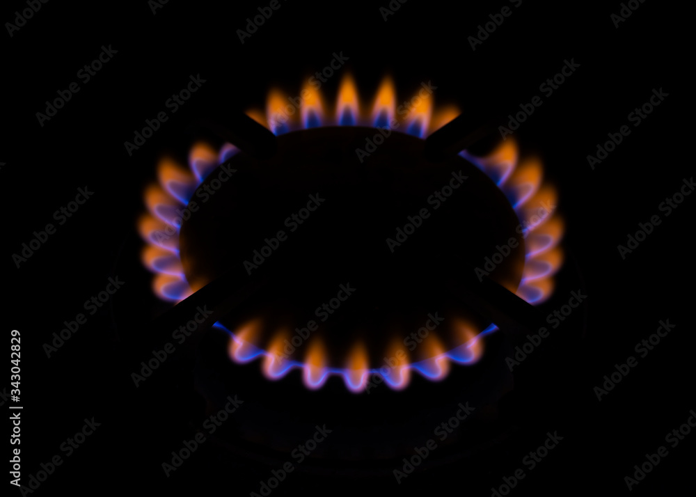Orange blue burning gas flame black background close up Orange blue burning gas flame black background close up