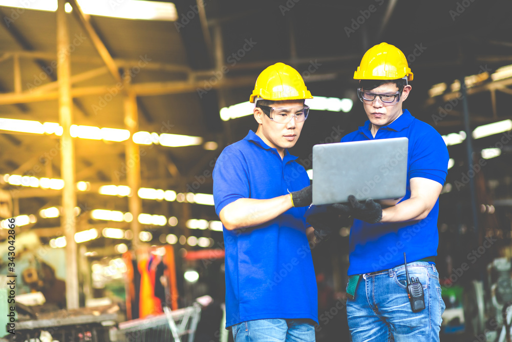 Professional Asian engineering Man Worker at industrial factory wearing uniform and hardhats . Engineer Operating lathe Machinery Professional Asian engineering Man Worker at industrial factory wearing uniform and hardhats . Engineer Operating lathe Machinery