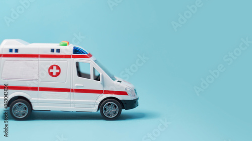 close up of the toy ambulance on blue background.