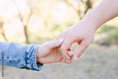 Couple Wife Husband Dating Relaxation Love Concept. Couple hands together touch with love. People, family, care and support concept - close up of young woman and man holding hands together