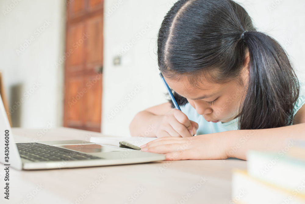 pretty stylish schoolgirl studying homework during online lesson at home, social distance during quarantine, self-isolation, online education concept, home school, study online video call teacher. pretty stylish schoolgirl studying homework during online lesson at home, social distance during quarantine, self-isolation, online education concept, home school, study online video call teacher.